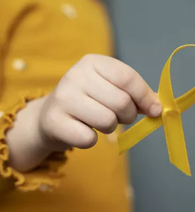 child-holding-yellow-ribbon